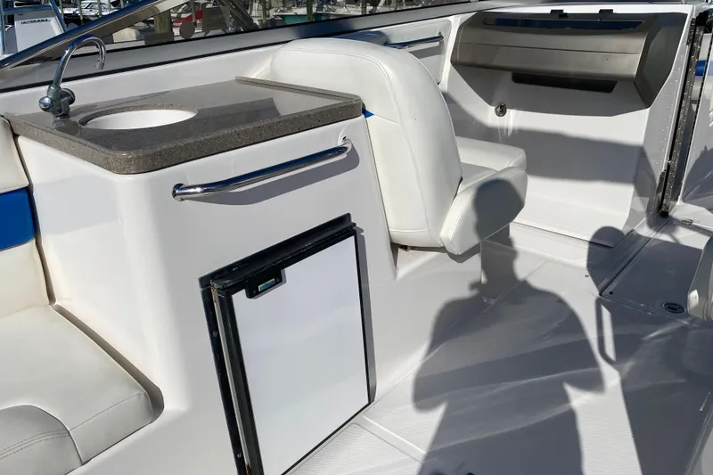 Slide: The Image of 2010 Regal 2700 ES Bowrider interior with sink, seating, and storage. - 26