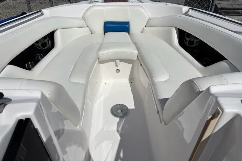 Slide: The Image of 2010 Regal 2700 ES Bowrider with blue cover, docked on gravel lot. - 8