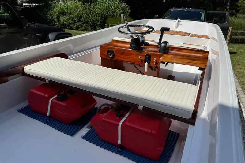 Slide: The Image of 1978 Boston Whaler Currituck boat interior with wooden console and white seating. - 3
