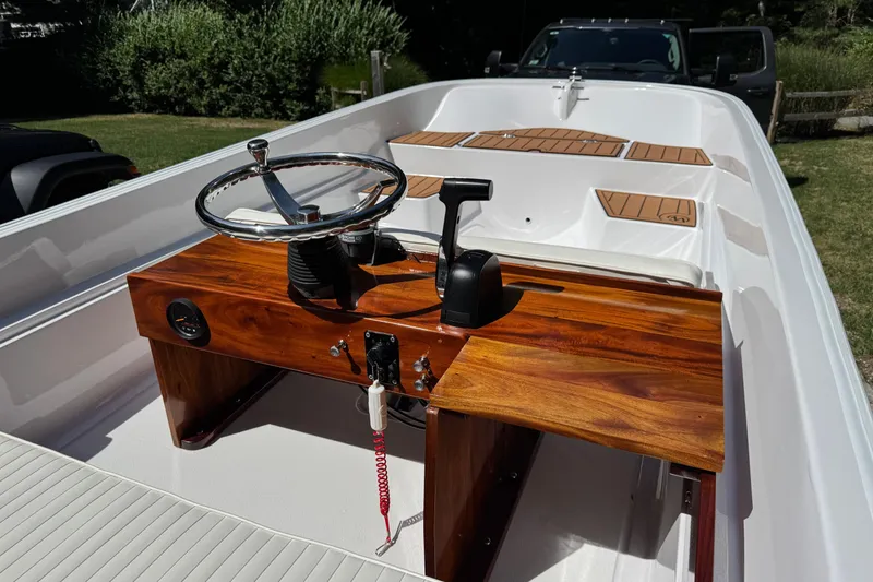 Slide: The Image of 1978 Boston Whaler Currituck boat interior with wooden console and steering wheel. - 4