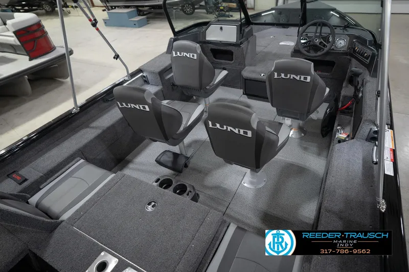 Slide: The Image of 2026 Lund 1875 Impact XS boat interior with seating and steering console. - 14