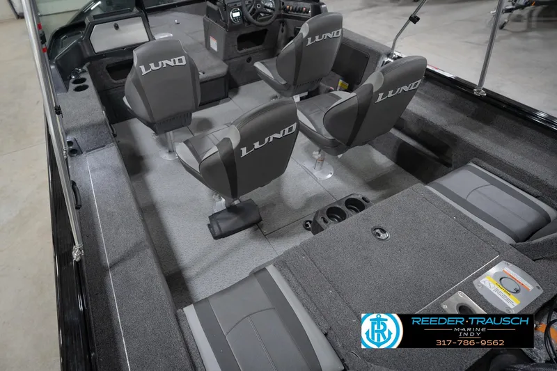 Slide: The Image of 2026 Lund 1875 Impact XS boat interior with seating and console, showcased by Reeder-Trausch Marine. - 15