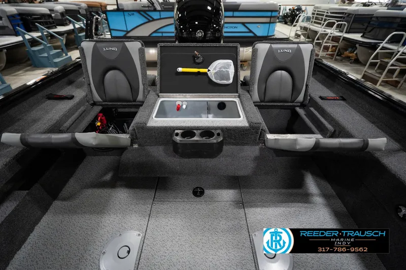 Slide: The Image of 2026 Lund 1875 Impact XS boat interior with seating and storage compartments. - 24