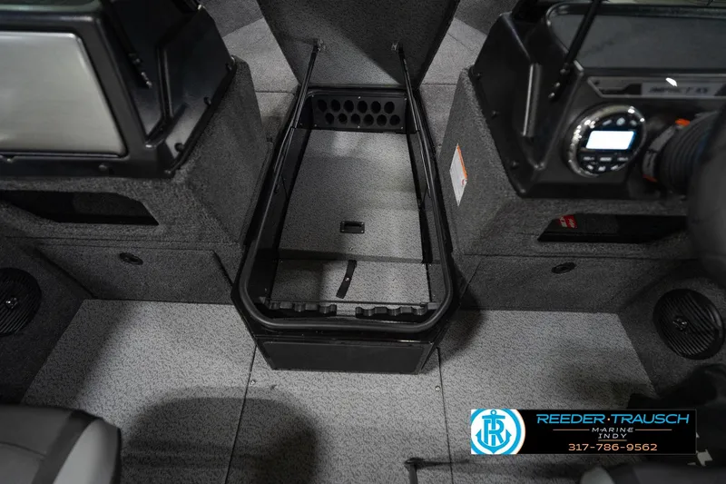 Slide: The Image of 2026 Lund 1875 Impact XS boat interior with storage compartment and control panel. - 26
