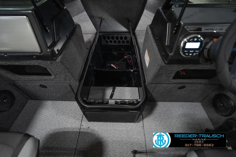Slide: The Image of 2026 Lund 1875 Impact XS boat interior with storage compartment and control panel. - 27