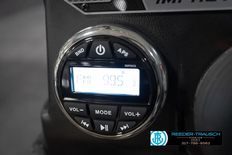 Slide: The Image of Close-up of 2026 Lund 1875 Impact XS radio display showing FM 99.5 station. - 37