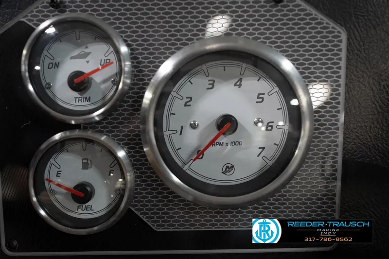 Slide: The Image of Dashboard gauges of 2026 Lund 1875 Impact XS boat, featuring RPM, trim, and fuel indicators. - 38