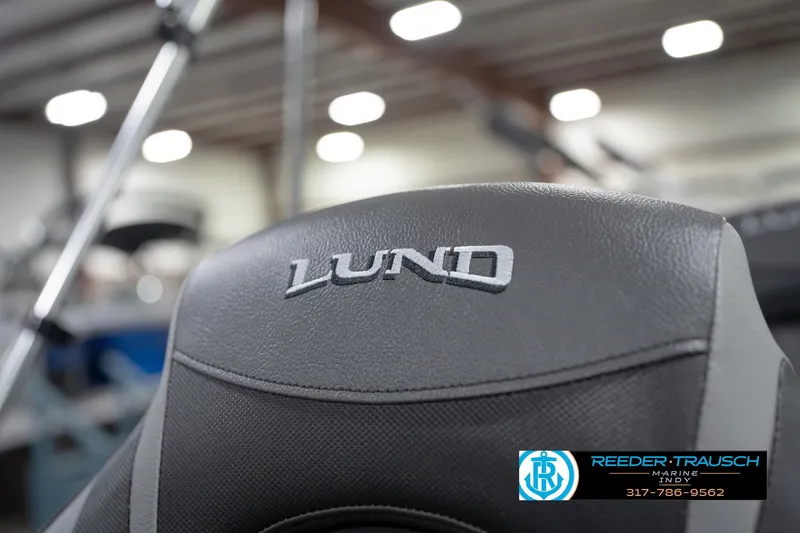 Slide: The Image of Close-up of 2026 Lund 1875 Impact XS boat seat with logo in showroom. - 43