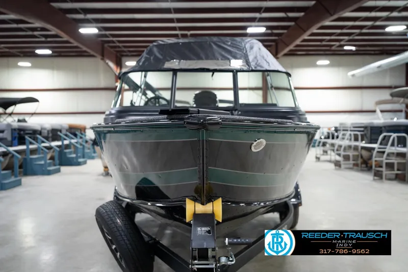 Slide: The Image of 2026 Lund 1875 Impact XS boat in showroom, front view, Reeder-Trausch Marine. - 5