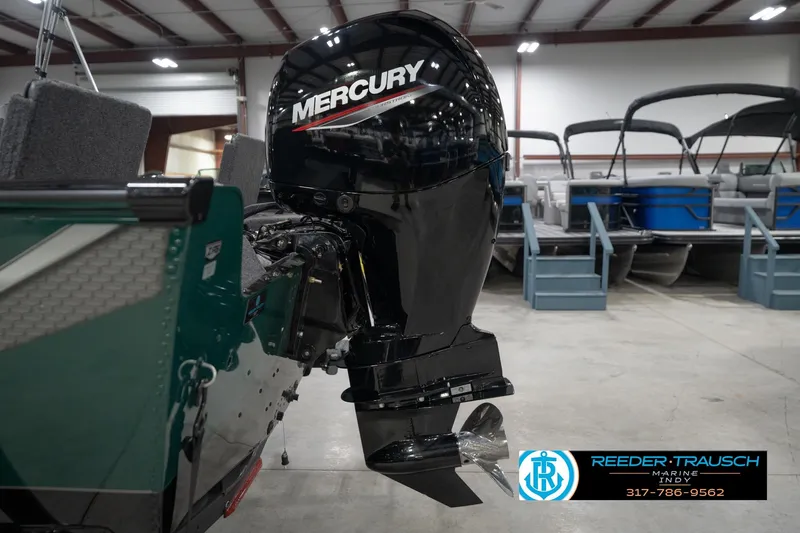 Slide: The Image of 2026 Lund 1875 Impact XS boat with Mercury outboard motor in showroom. - 50