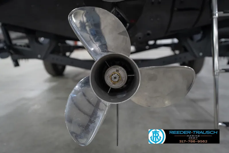 Slide: The Image of Propeller of 2026 Lund 1875 Impact XS boat in a showroom setting. - 54