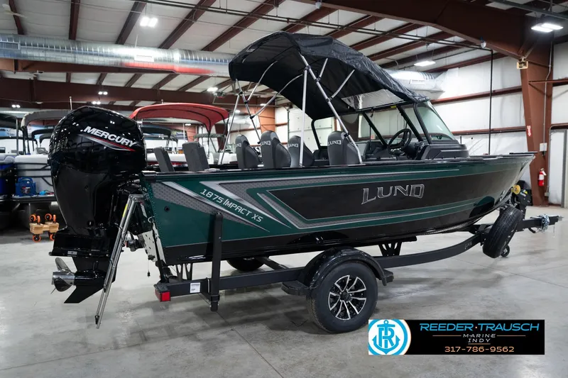Slide: The Image of 2026 Lund 1875 Impact XS boat with Mercury engine in showroom. - 8