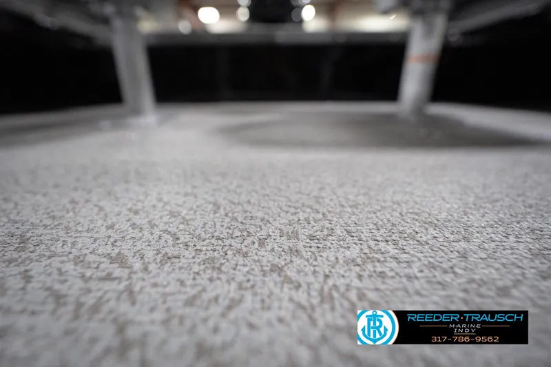 Slide: The Image of 2026 Lund 1800 Explorer Sport boat interior with textured flooring, Reeder-Trausch Marine logo. - 102