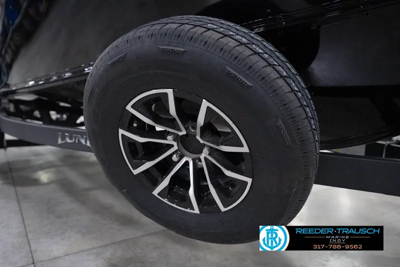 Slide: The Image of 2026 Lund 1800 Explorer Sport trailer wheel, black and silver design, Reeder-Trausch Marine logo. - 113