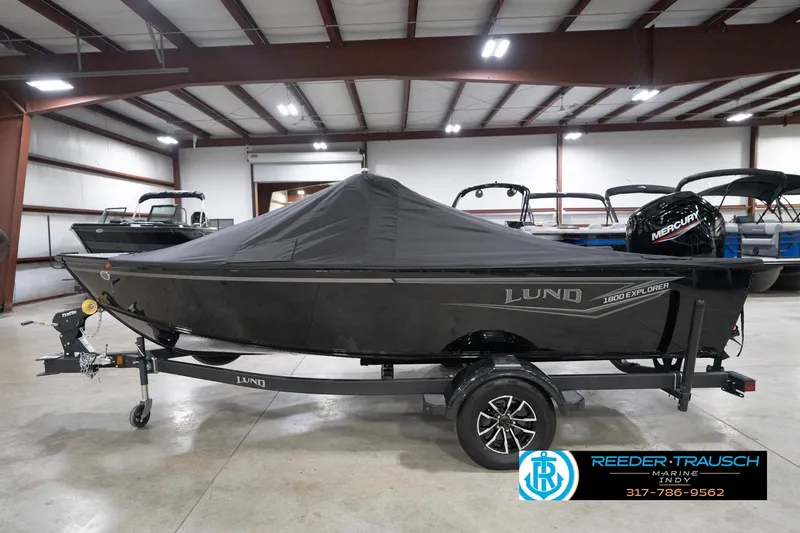 Slide: The Image of 2026 Lund 1800 Explorer Sport boat with cover in indoor showroom. - 114