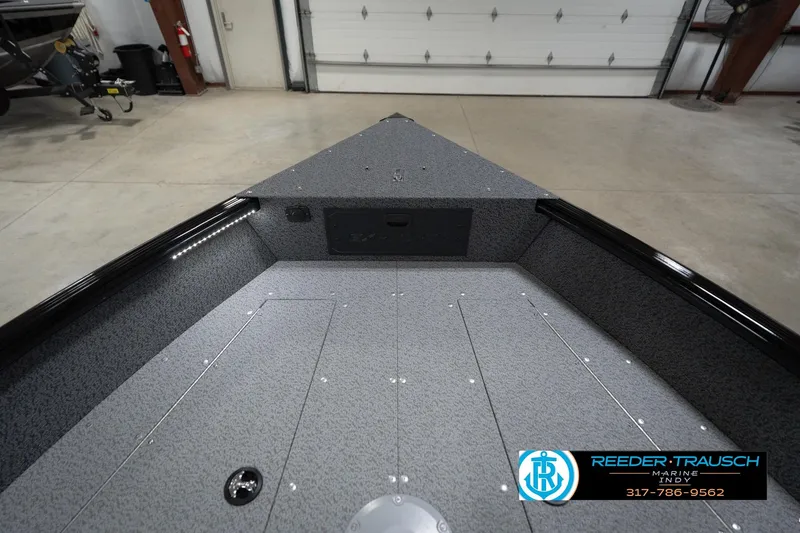 Slide: The Image of 2026 Lund 1800 Explorer Sport boat interior with branded seats in a showroom. - 18