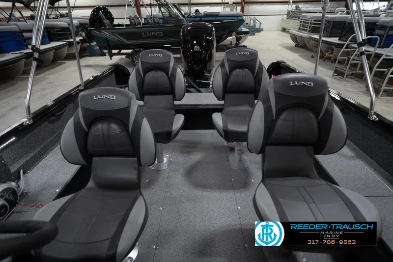 Slide: The Image of 2026 Lund 1800 Explorer Sport boat interior with steering wheel and dashboard in showroom. - 20