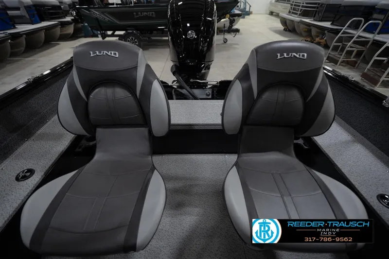 Slide: The Image of 2026 Lund 1800 Explorer Sport boat interior in a showroom setting. - 21