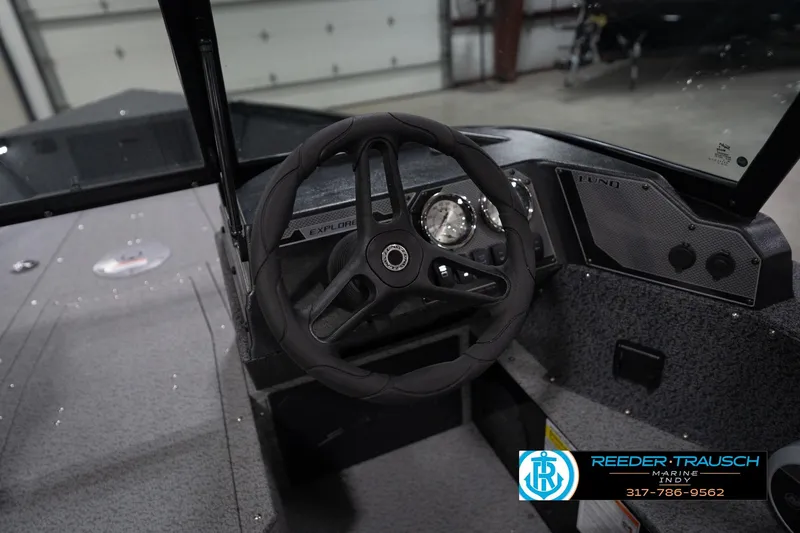 Slide: The Image of Interior storage compartment of 2026 Lund 1800 Explorer Sport boat, featuring carpeted lining. - 32