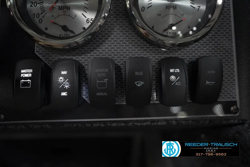 Slide: The Image of 2026 Lund 1800 Explorer Sport boat interior with storage compartments and Reeder-Trausch Marine logo. - 35