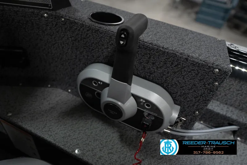 Slide: The Image of 2026 Lund 1800 Explorer Sport boat dashboard with steering wheel and gauges. - 38