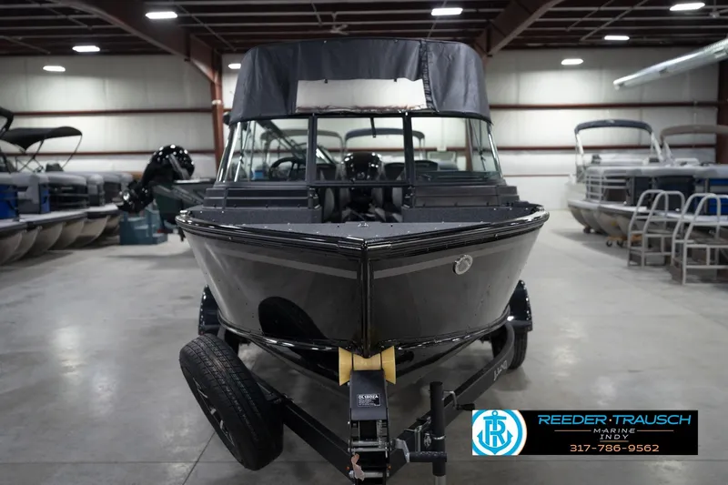 Slide: The Image of 2026 Lund 1800 Explorer Sport boat on trailer in showroom setting. - 5