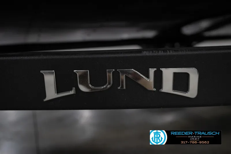 Slide: The Image of Close-up of 2026 Lund 1800 Explorer Sport logo in a showroom setting. - 54