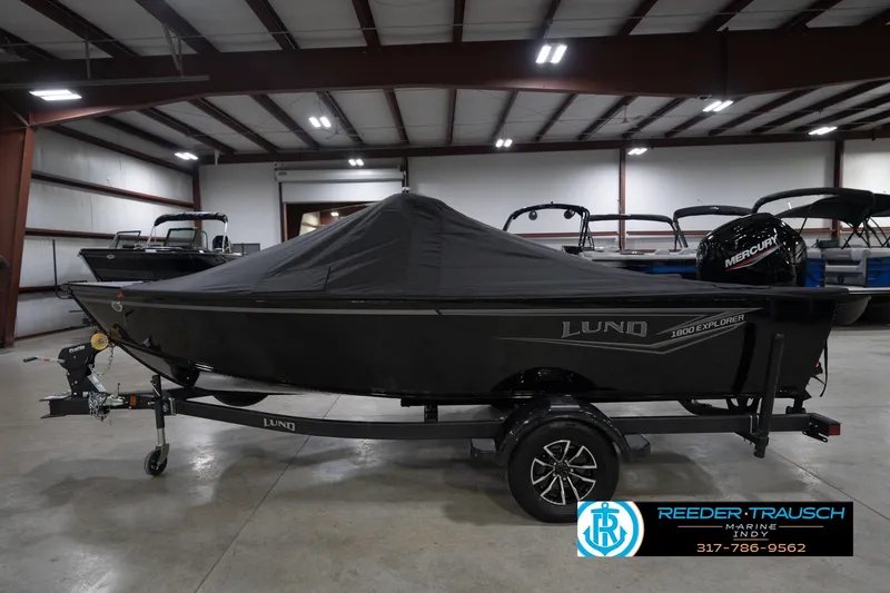 Slide: The Image of 2026 Lund 1800 Explorer Sport boat side view in showroom setting. - 56