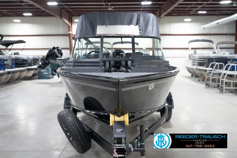 Slide: The Image of 2026 Lund 1800 Explorer Sport boat in showroom, front view, on trailer. - 63