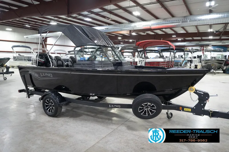 Slide: The Image of 2026 Lund 1800 Explorer Sport boat on trailer in showroom setting. - 64