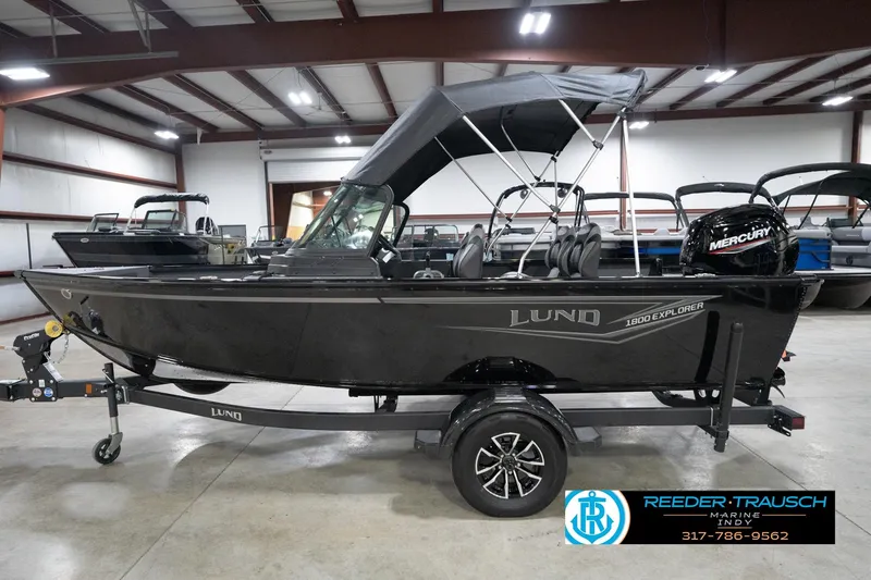 Slide: The Image of 2026 Lund 1800 Explorer Sport boat in showroom with Mercury engine. - 69