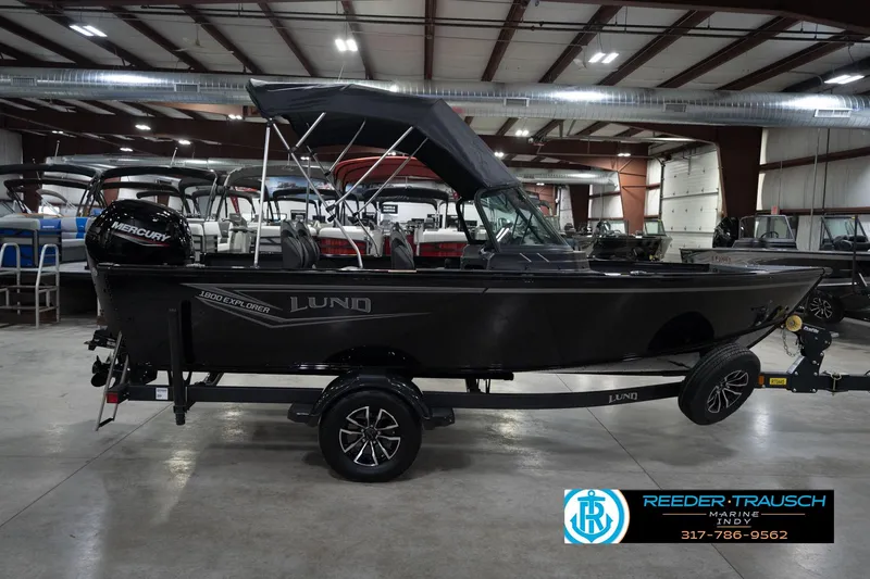 Slide: The Image of 2026 Lund 1800 Explorer Sport boat on water, promoting trade-in program for various vehicles. - 7