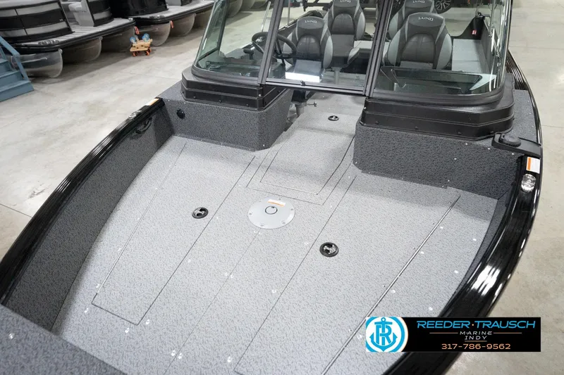 Slide: The Image of 2026 Lund 1800 Explorer Sport boat interior with seating and windshield in showroom. - 70