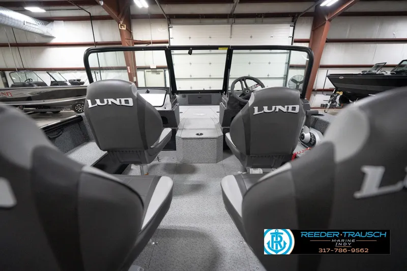 Slide: The Image of 2026 Lund 1800 Explorer Sport boat interior with branded seats in a showroom. - 74