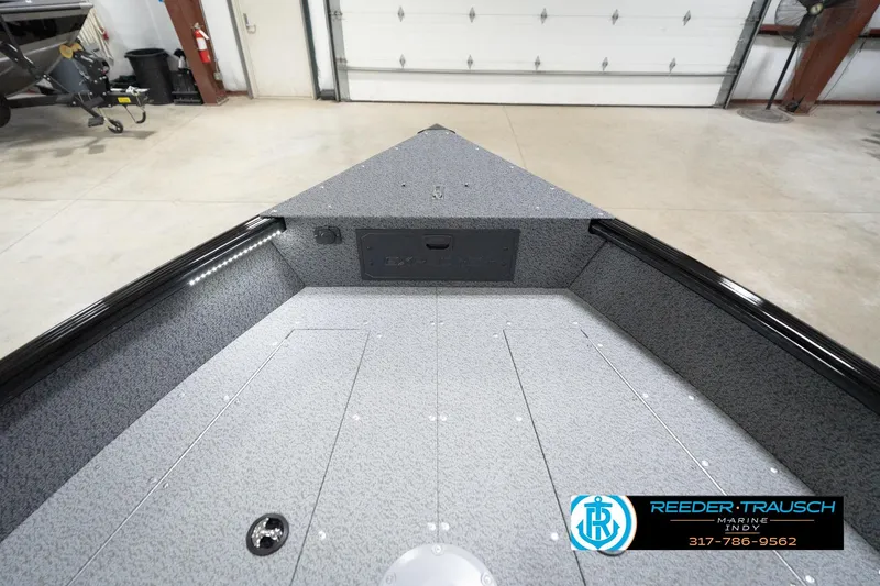 Slide: The Image of 2026 Lund 1800 Explorer Sport boat interior in a showroom setting. - 76