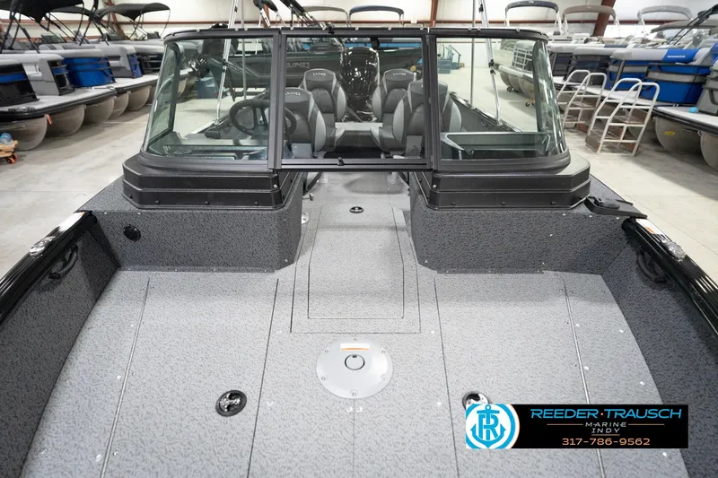 Slide: The Image of 2026 Lund 1800 Explorer Sport boat interior in showroom, featuring spacious seating and modern design. - 77