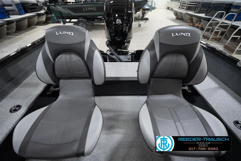 Slide: The Image of 2026 Lund 1800 Explorer Sport boat seats in showroom, featuring sleek gray design. - 79