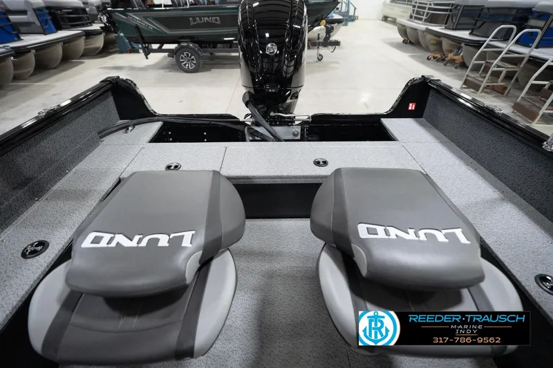 Slide: The Image of 2026 Lund 1800 Explorer Sport boat interior with branded seats in a showroom. - 80
