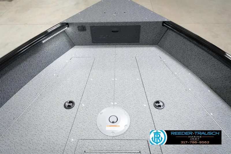 Slide: The Image of 2026 Lund 1800 Explorer Sport boat interior with storage compartments and Reeder-Trausch Marine logo. - 87