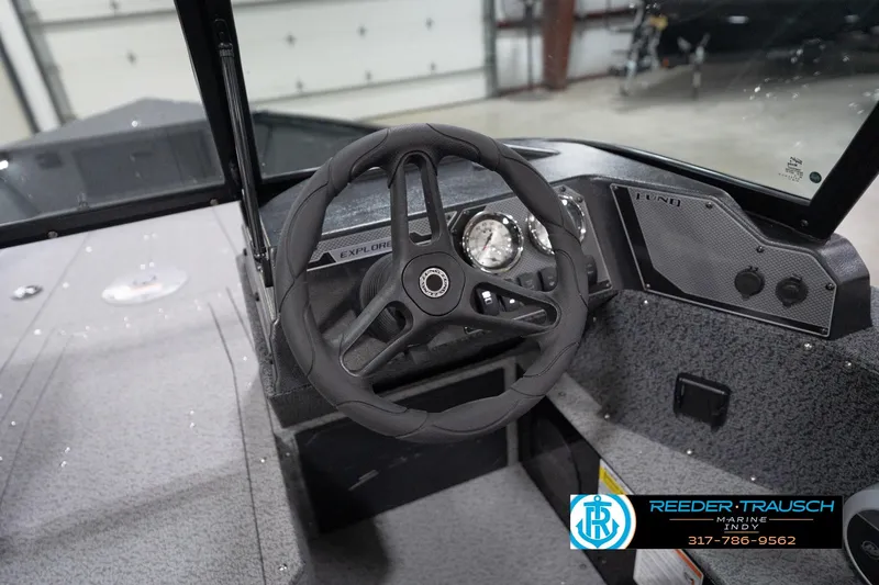 Slide: The Image of 2026 Lund 1800 Explorer Sport boat dashboard with steering wheel and gauges. - 90