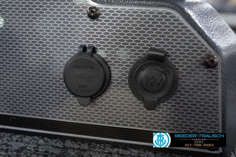 Slide: The Image of 2026 Lund 1800 Explorer Sport boat dashboard with USB and 12V power outlets. - 95