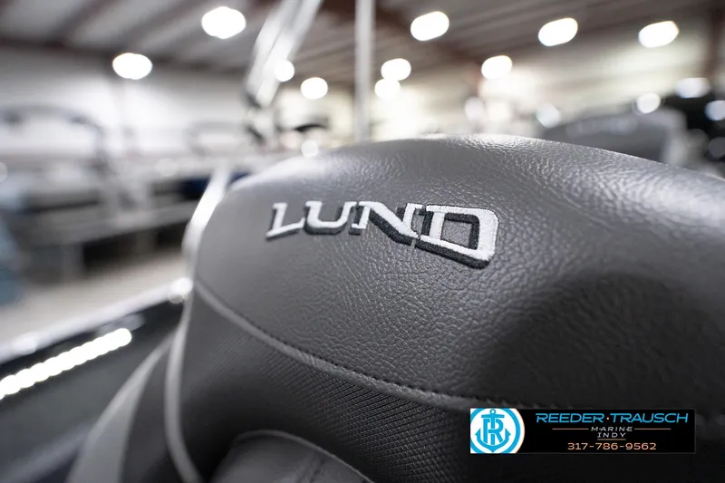 Slide: The Image of Close-up of 2026 Lund 1800 Explorer Sport seat with logo in showroom. - 98
