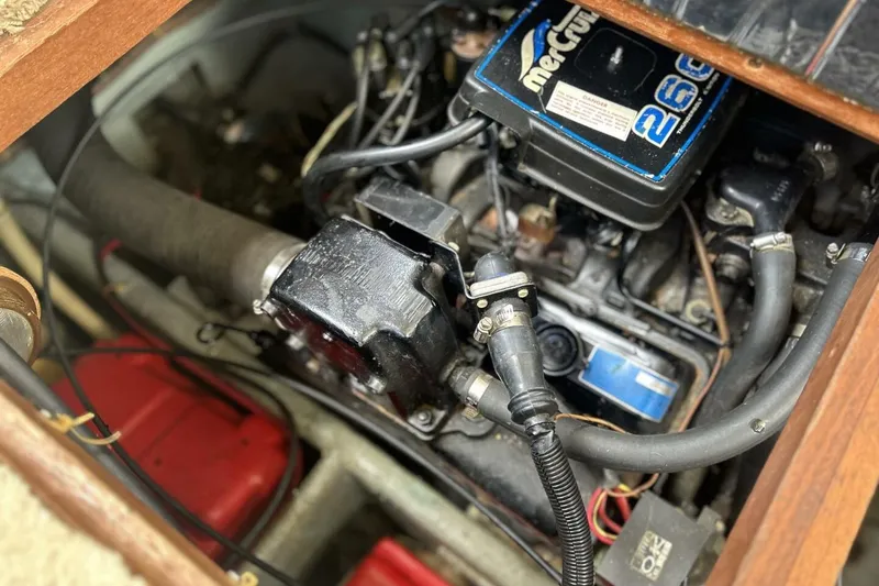Slide: The Image of Engine compartment of a 1985 Carver 3207 Aft Cabin boat, featuring a MerCruiser 260 engine. - 28