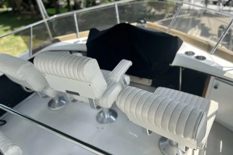 Slide: The Image of 1985 Carver 3207 Aft Cabin boat interior with white cushioned seating. - 10