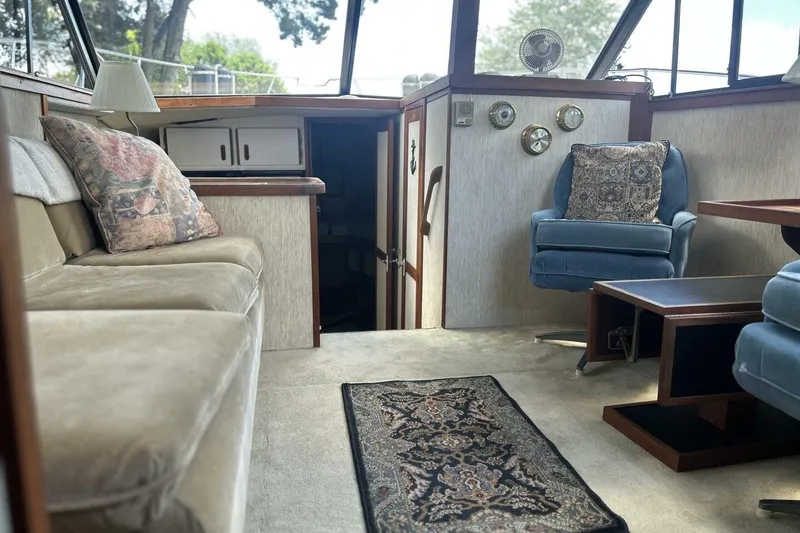 Slide: The Image of Interior of 1985 Carver 3207 Aft Cabin with cozy seating and nautical decor. - 17