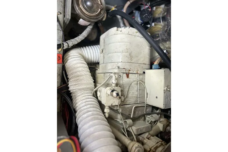 Slide: The Image of Engine compartment of 1985 Carver 3207 Aft Cabin boat, showing mechanical components and hoses. - 25