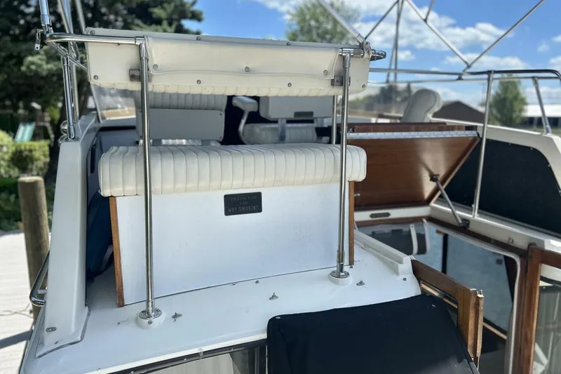 Slide: The Image of 1985 Carver 3207 Aft Cabin boat with white seating and open deck view. - 9