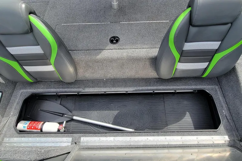 Slide: The Image of 2023 Ranger RT188 boat storage compartment with paddle and fire extinguisher. - 10