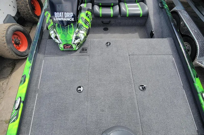 Slide: The Image of 2023 Ranger RT188 boat interior with custom green graphics and gray seating. - 7