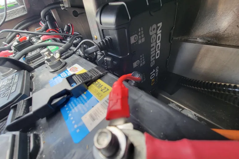 Slide: The Image of Battery setup in a 2023 Ranger RT188 with NOCO Genius charger and cables. - 9